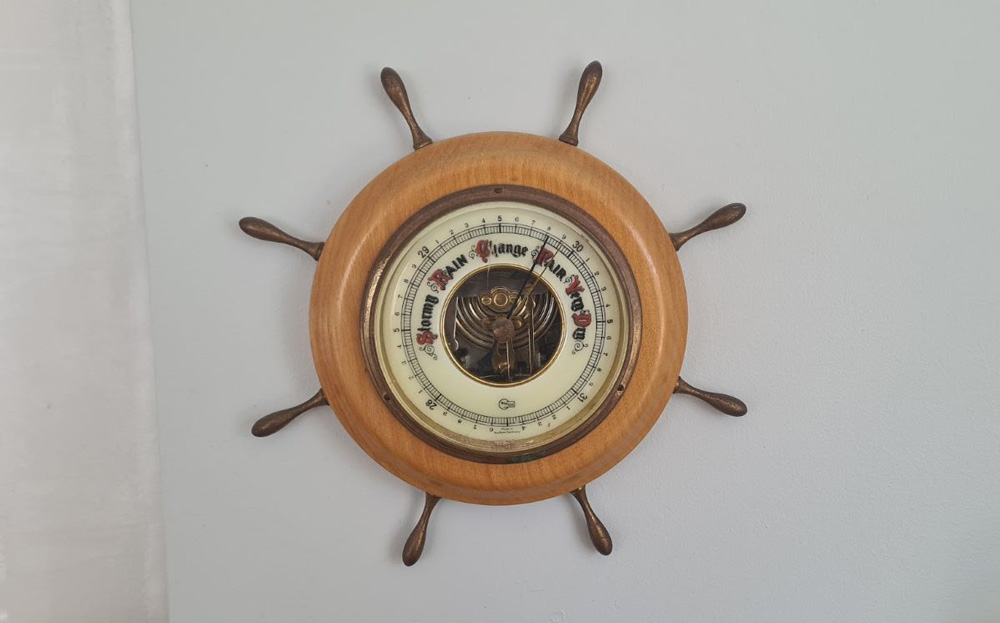 old-style barometer hanging on a wall