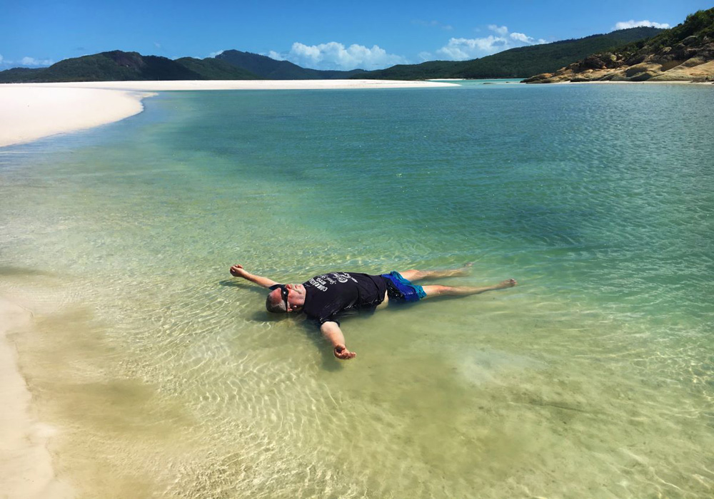 The author lying on on his back in northern river